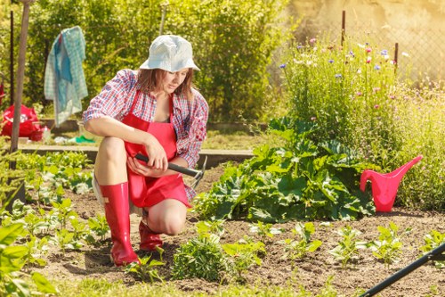 Supervisor training staff on safe use of gardening equipment